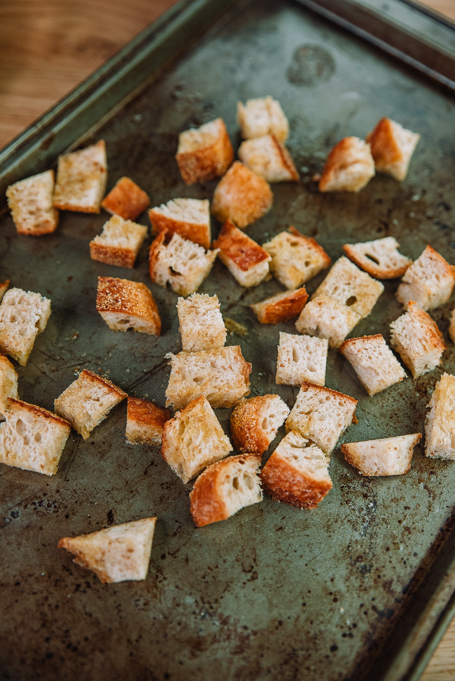 Freshly baked croutons on a baking sheet. Kale Caesar Salad recipe by Farmer's Market Society l Market Inspired Meals.