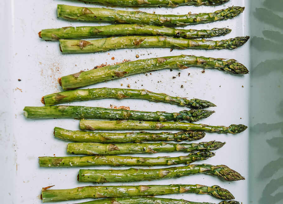 Roasted asparagus in a white baking dish