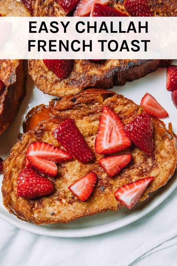 Thick luscious slices of French toast made with challah bread from the farmers market for easy homemade brunch topped with fresh strawberries. #brunch #frenchtoast #farmersmarket #strawberries