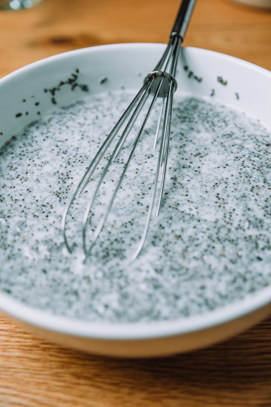 White bowl with milk and chia seeds